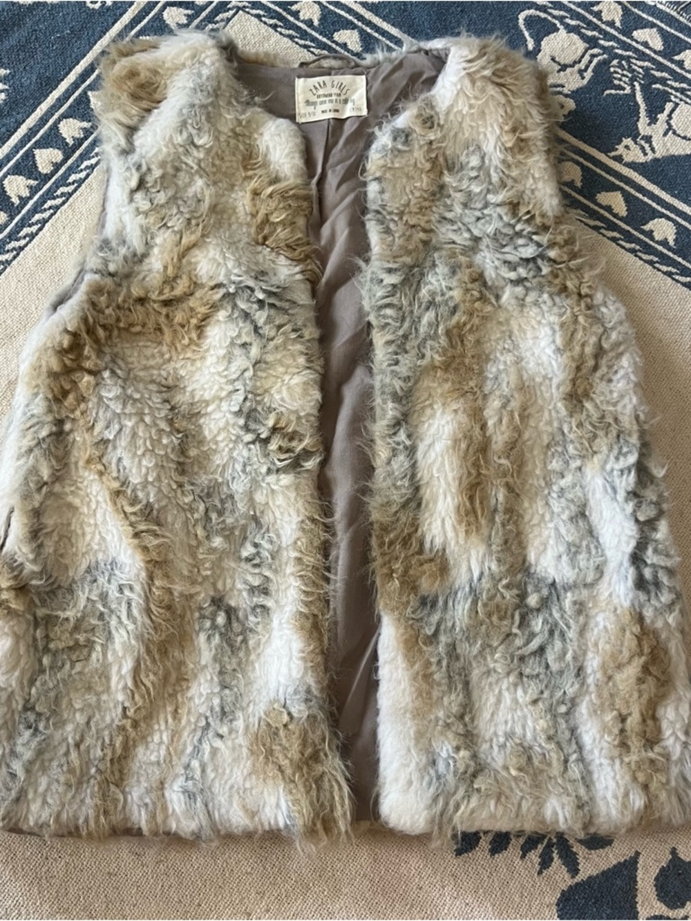 gray brown and white faux fur vest jacket.